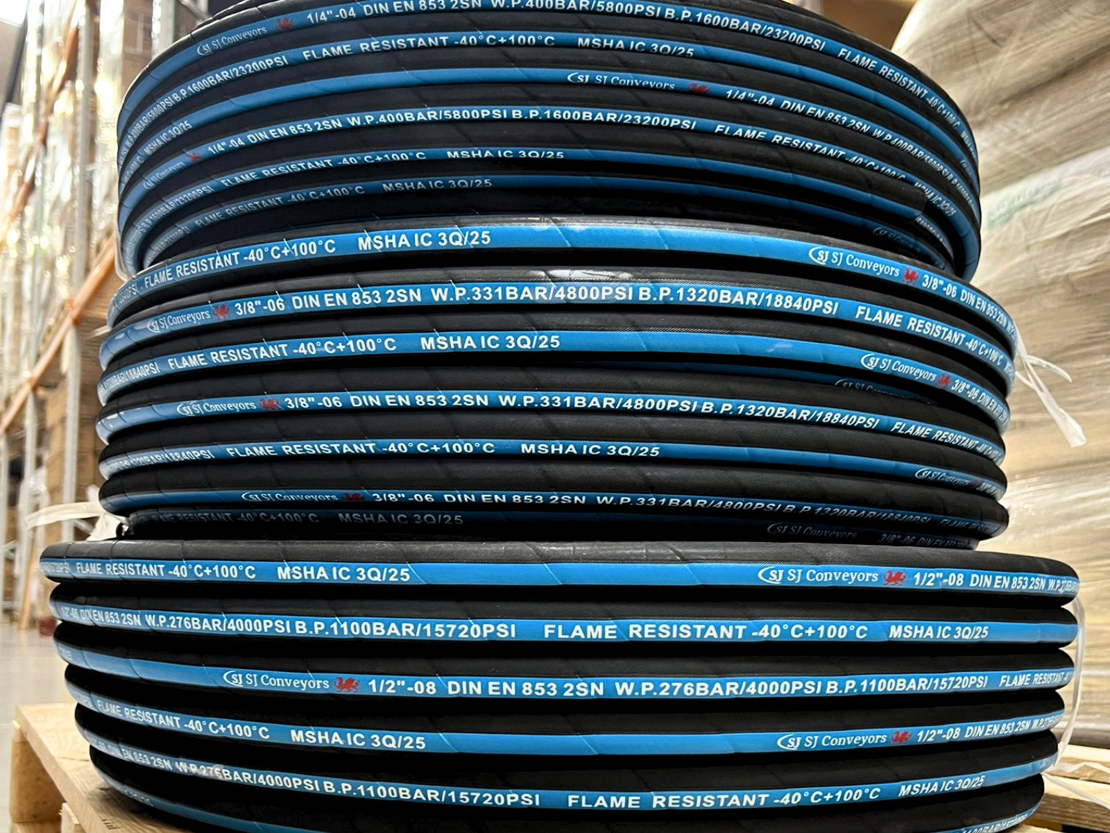 Bulk coils of custom printed hydraulic hose ready for dispatch